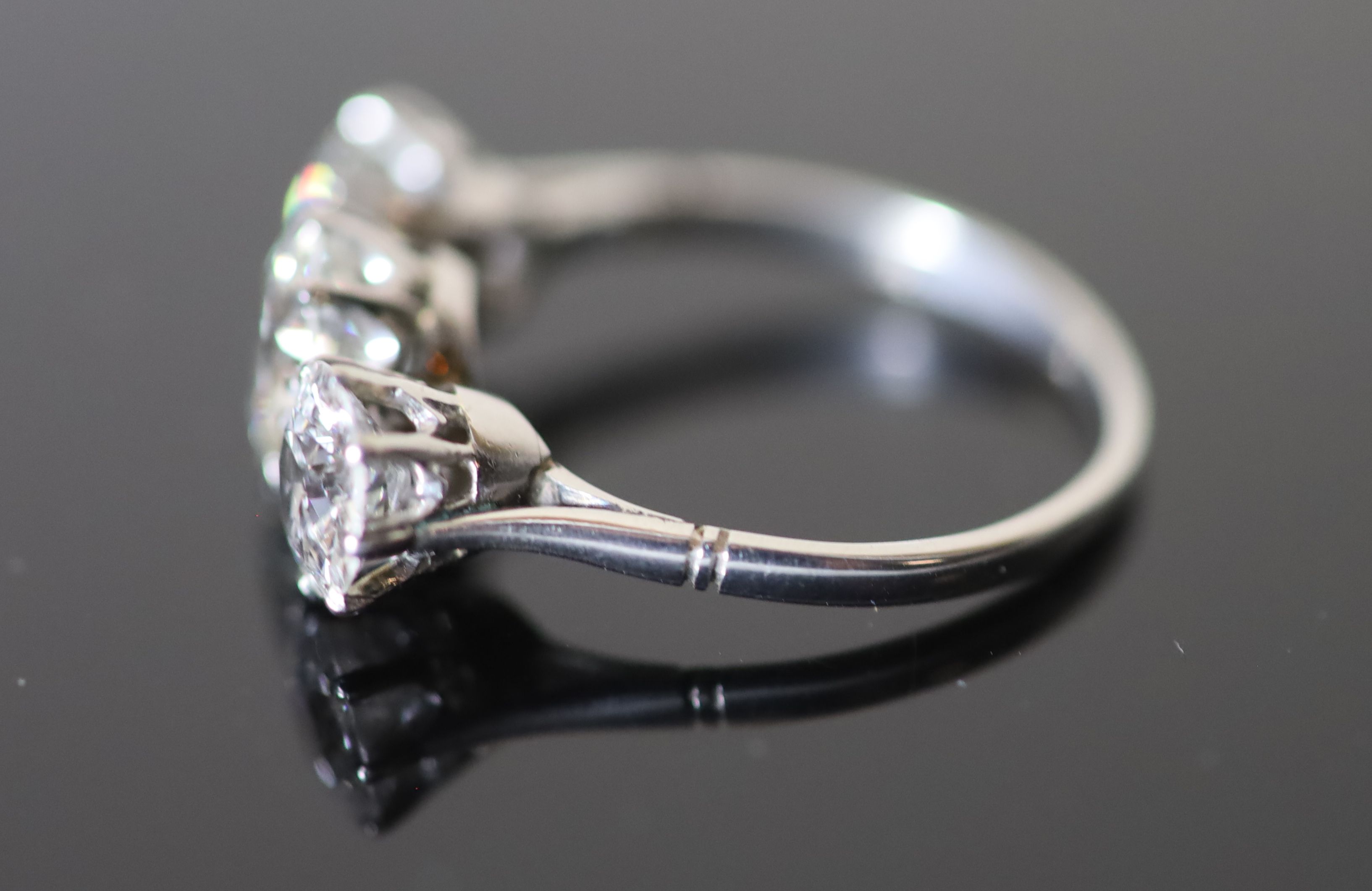 A platinum and three stone diamond ring,